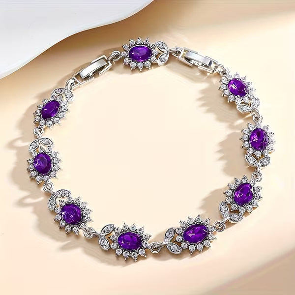 Zilverkleurige bloemenarmband met amethistpaarse steentjes