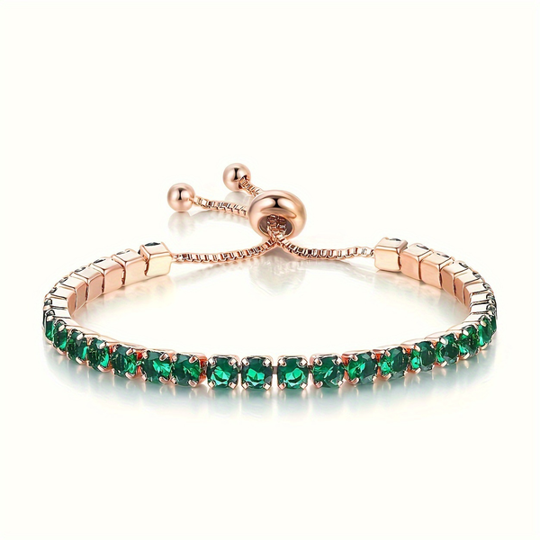 Goudkleurige verstelbare tennisarmband met smaragdgroene steentjes