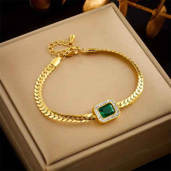 Goudkleurige schakelarmband met smaragdgroene steen