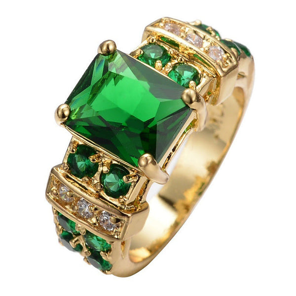 Goudkleurige geometrische ring met smaragdgroene steen