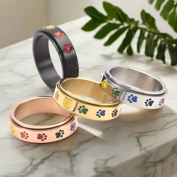 Draaiende anti-stress ring met pootjes – roestvrij staal met regenboogpootjes