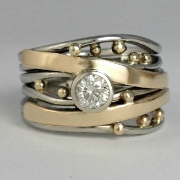 Zilver- en goudkleurige wikkelring met kastzetting