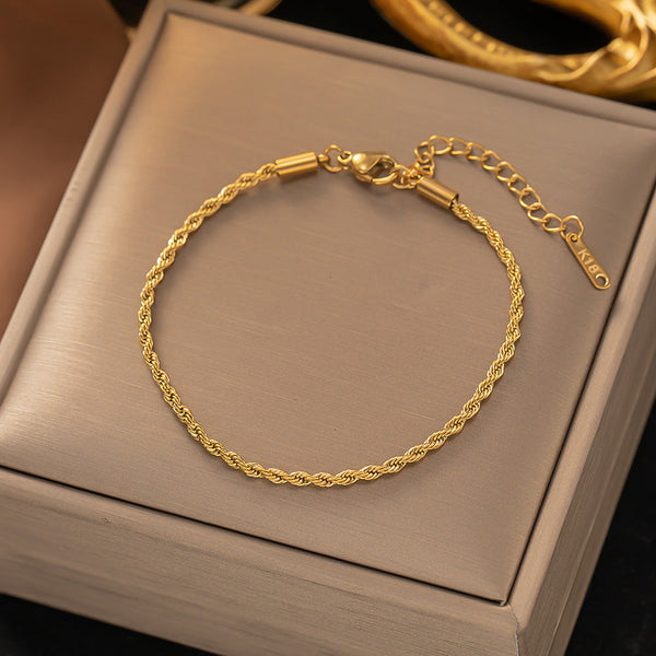 Gedraaide schakelarmband | goudkleurig