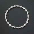Klassieke tennisarmband met clusters | witgoudkleurig
